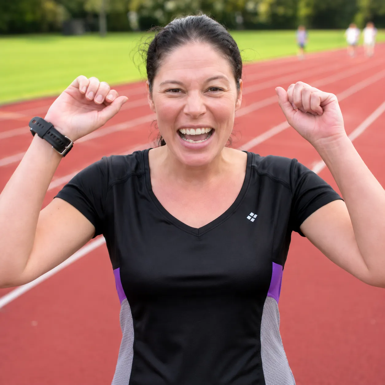 Lisa celebrating on the running track after passing her police fitness test